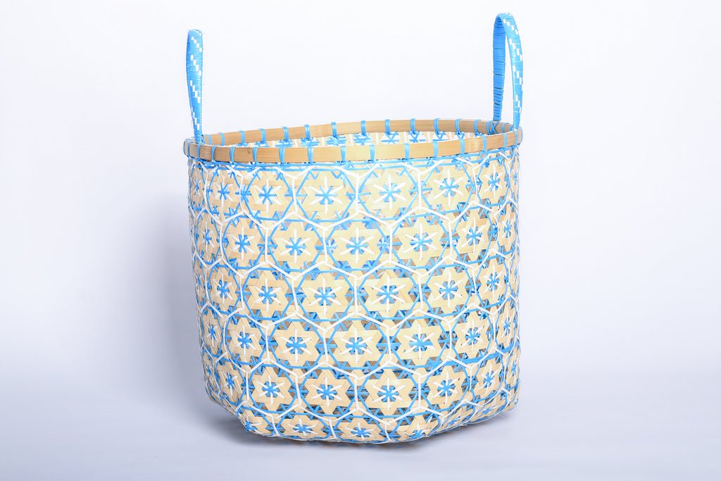 Faustina Blue Festive Star Laundry Hamper crafted from 100% natural plant fiber, featuring a celestial star motif that transforms a functional item into a decorative accent. Durable and eco-friendly, this hamper enhances your living space while supporting sustainable craftsmanship.