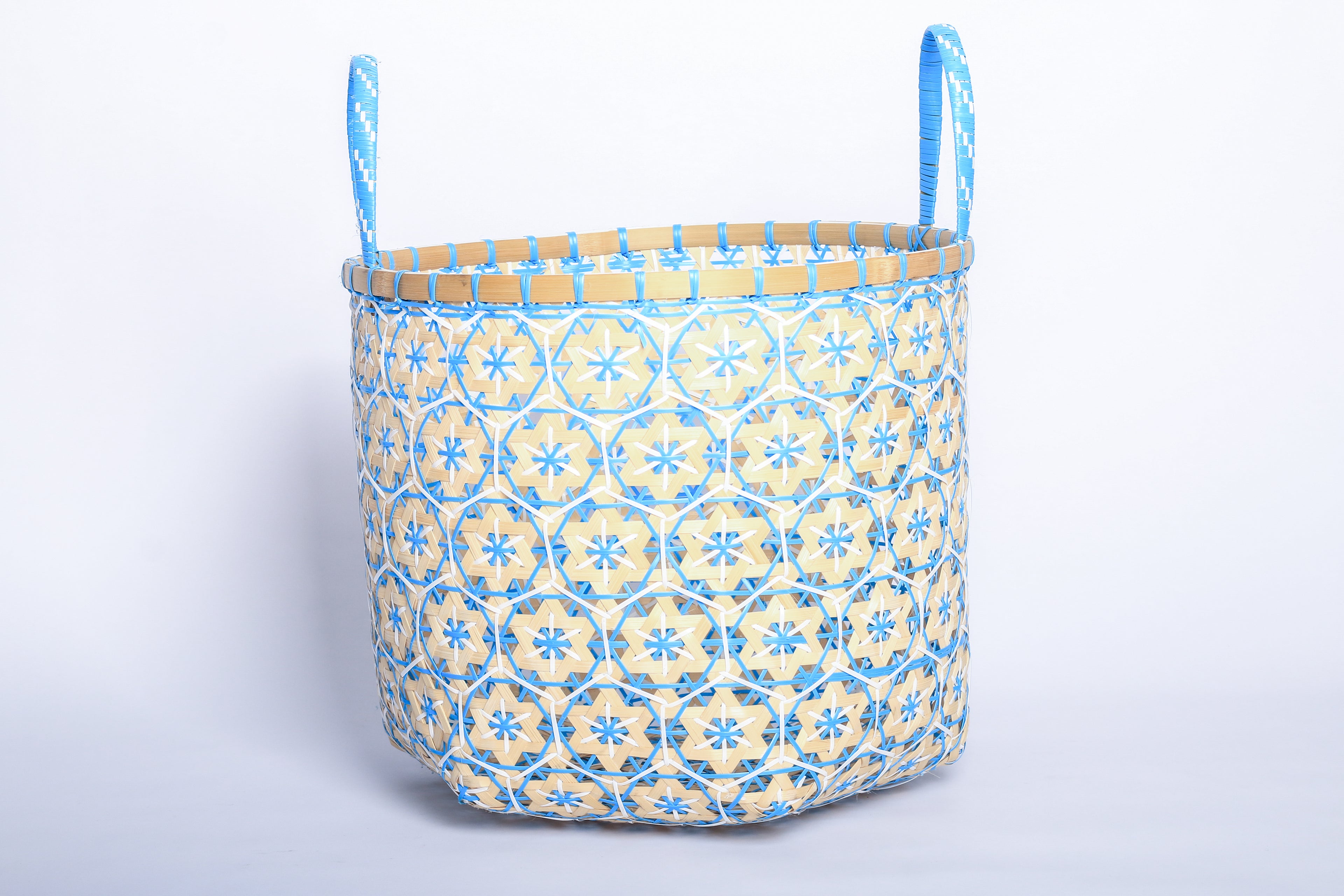 Faustina Blue Festive Star Laundry Hamper crafted from 100% natural plant fiber, featuring a celestial star motif that transforms a functional item into a decorative accent. Durable and eco-friendly, this hamper enhances your living space while supporting sustainable craftsmanship.