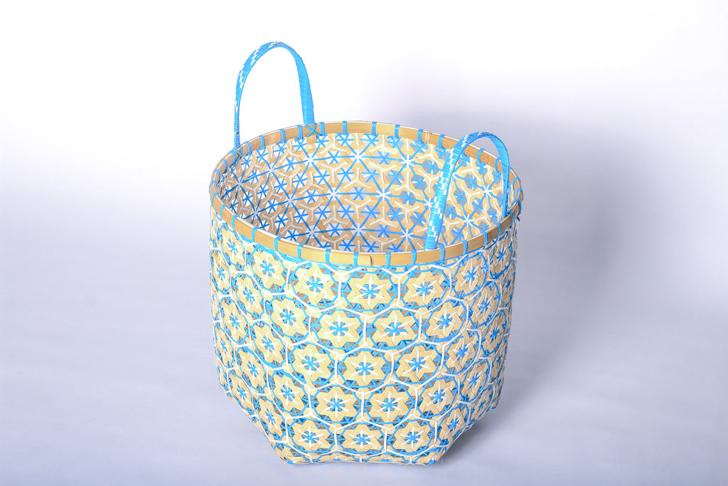 Faustina Blue Festive Star Laundry Hamper crafted from 100% natural plant fiber, featuring a celestial star motif that transforms a functional item into a decorative accent. Durable and eco-friendly, this hamper enhances your living space while supporting sustainable craftsmanship.