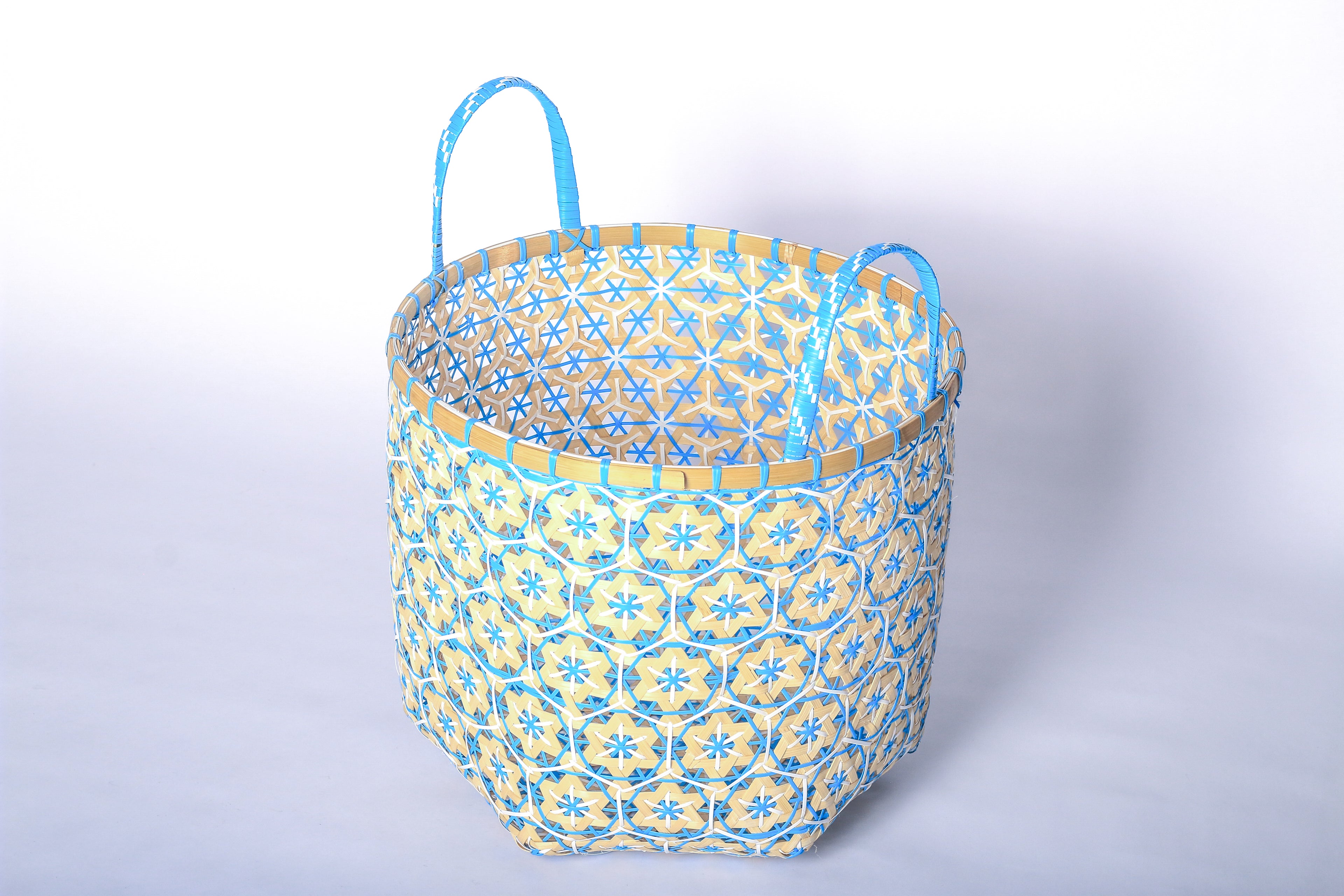 Faustina Blue Festive Star Laundry Hamper crafted from 100% natural plant fiber, featuring a celestial star motif that transforms a functional item into a decorative accent. Durable and eco-friendly, this hamper enhances your living space while supporting sustainable craftsmanship.