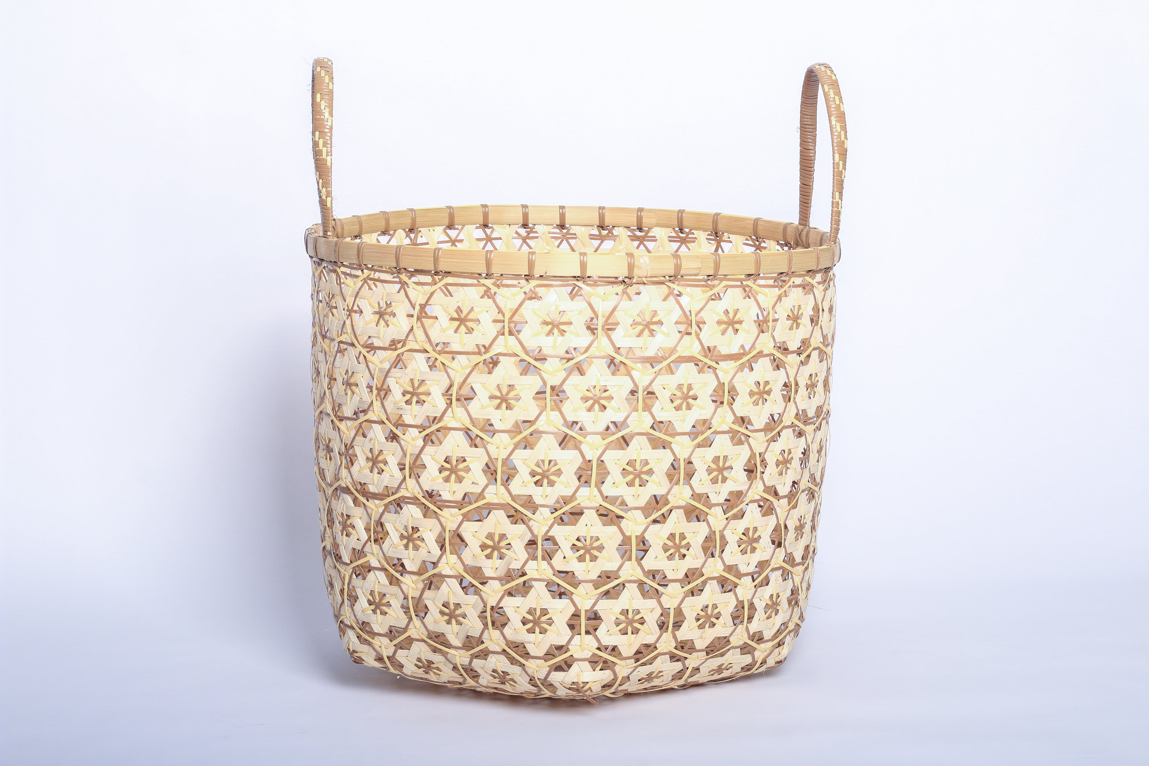 Faustina Nude Festive Star Laundry Hamper crafted from 100% natural plant fiber, featuring a celestial star motif that transforms a functional item into a decorative accent. Durable and eco-friendly, this hamper enhances your living space while supporting sustainable craftsmanship.