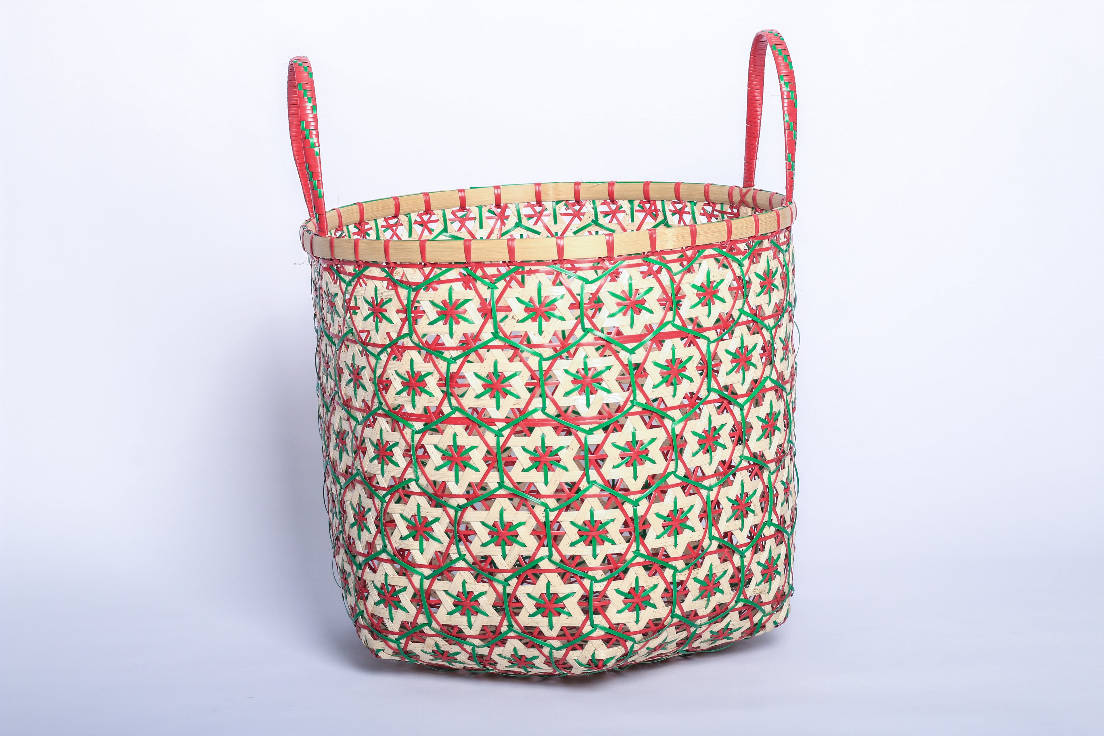 Faustina Red Festive Star Laundry Hamper crafted from 100% natural plant fiber, featuring a celestial star motif that transforms a functional item into a decorative accent. Durable and eco-friendly, this hamper enhances your living space while supporting sustainable craftsmanship.