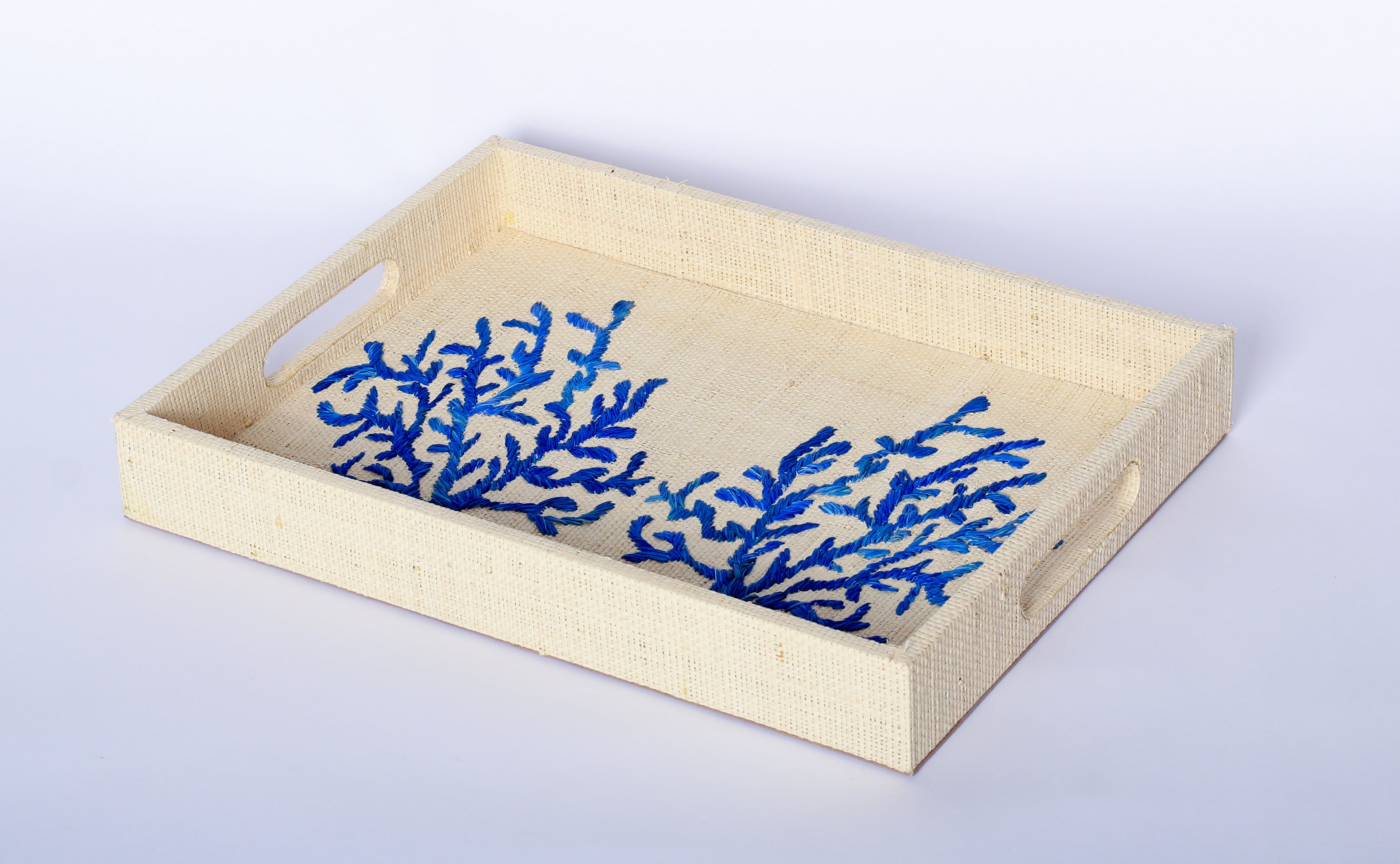 Elevate your home decor with Penelope Coral Blue Embroidered Trays made from eco-friendly raffia. Featuring elegant embroidery, these versatile trays serve as both functional and stylish accents for organizing or serving.