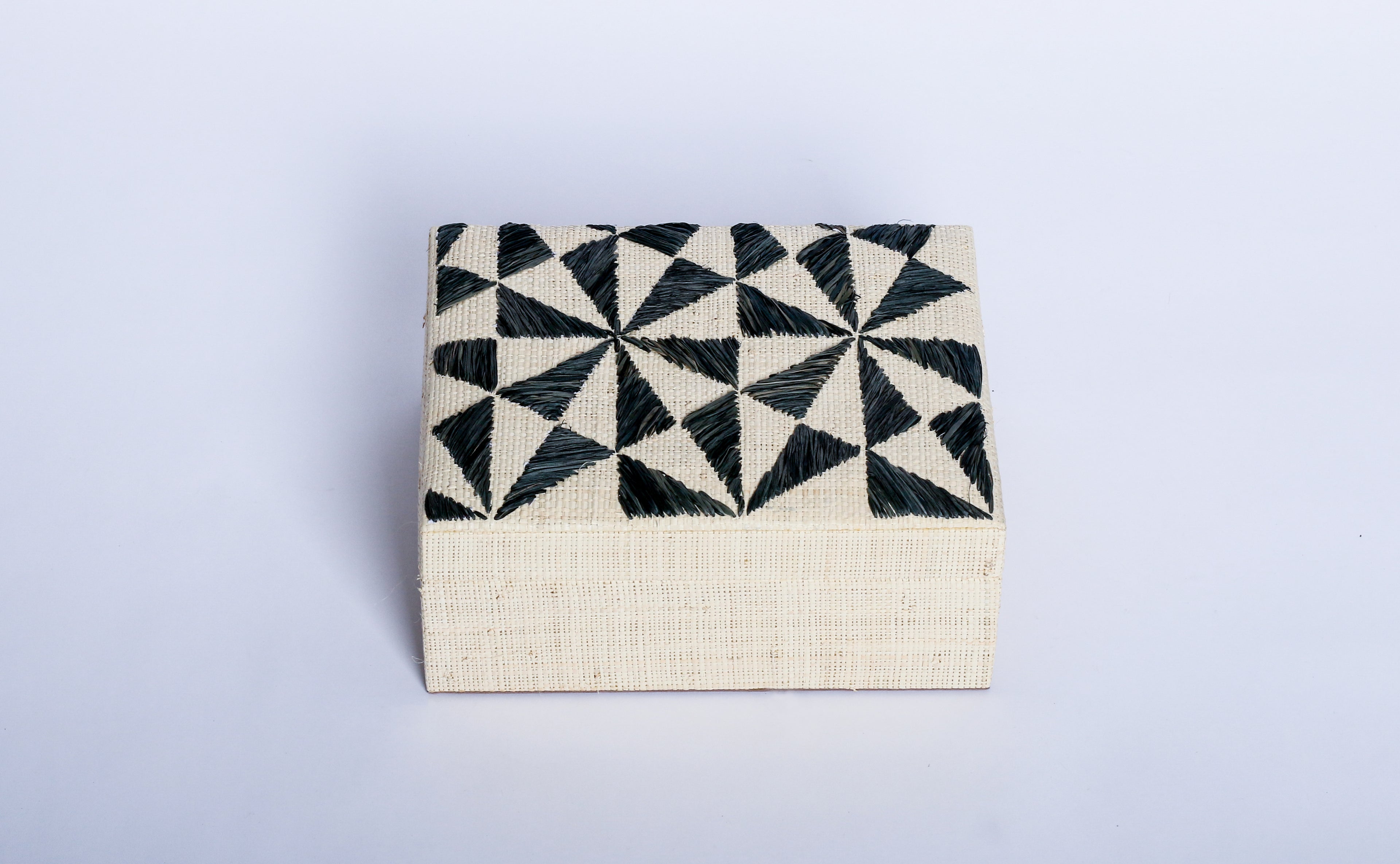 Store your jewelry in style with the Penelope Geometric Triangles Embroidery Jewelry Box. Made from eco-friendly materials and featuring intricate embroidery, this sustainable box combines function and elegance for your vanity or dresser.