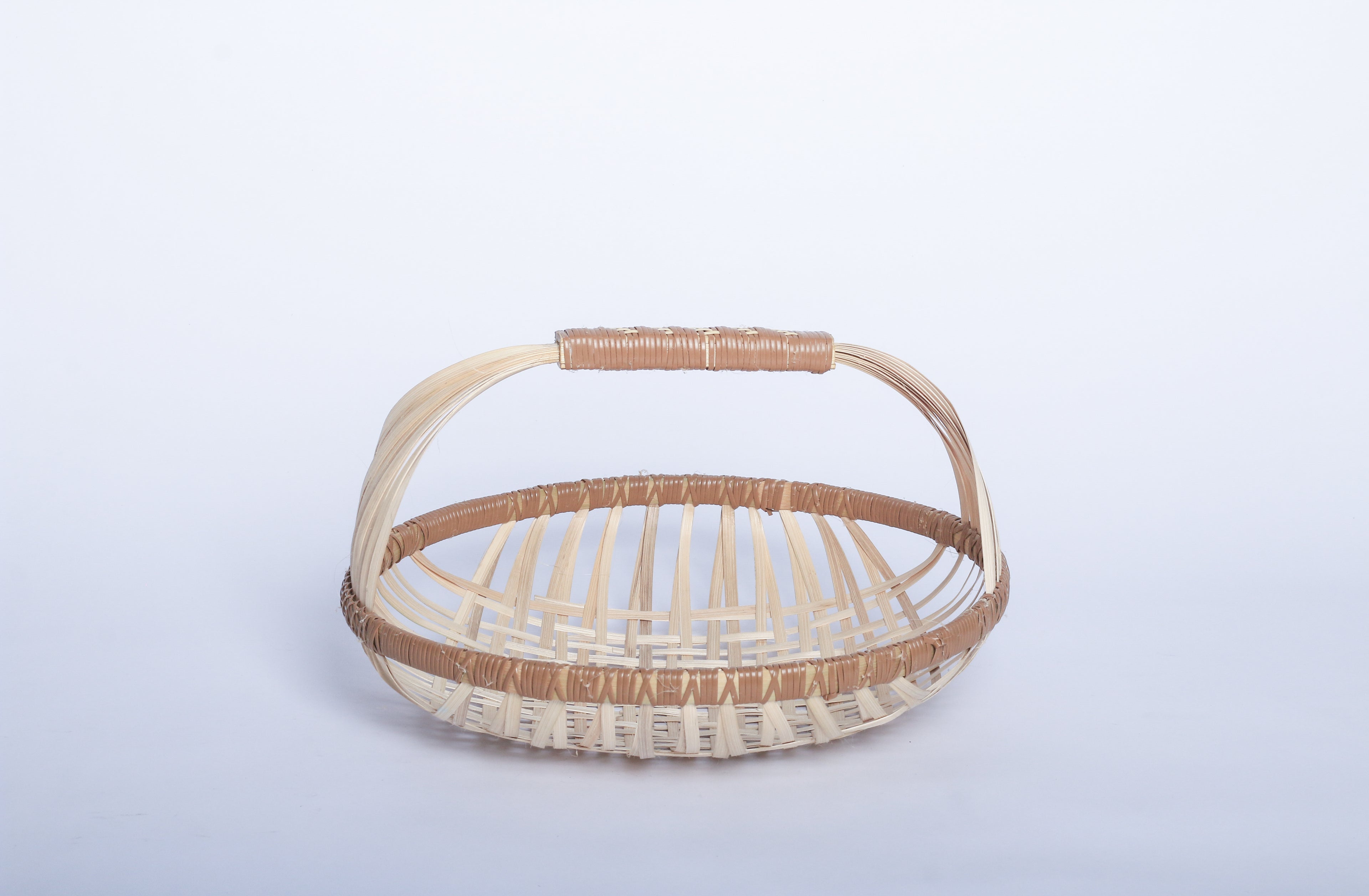 Plain Pale Faustina Festive Fruit Basket with Handle, crafted from eco-friendly materials, perfect for carrying fresh produce, organizing kitchen essentials, or adding a decorative touch to your home. Features a sturdy handle and vibrant design for culinary adventures.