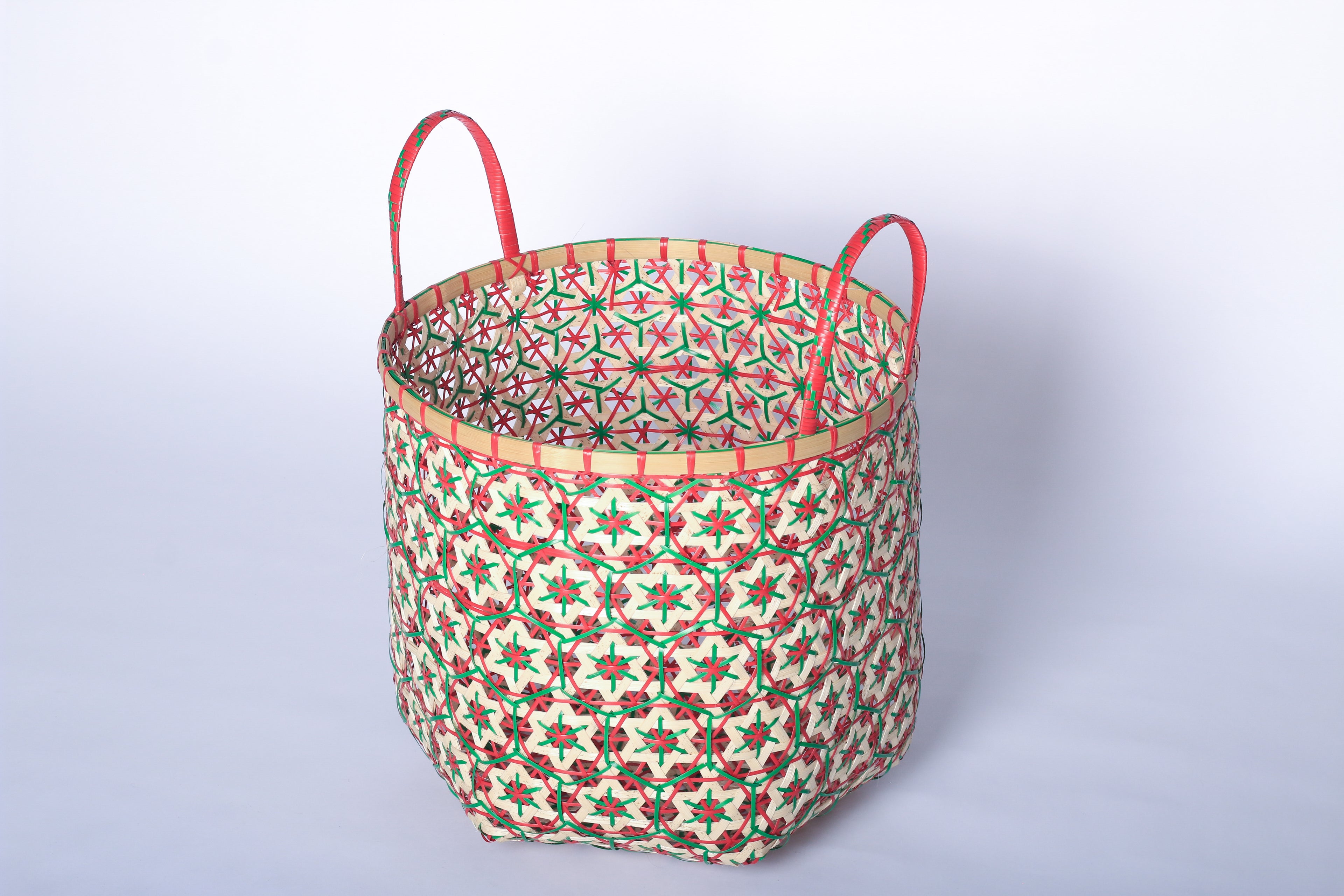 Faustina Red Festive Star Laundry Hamper crafted from 100% natural plant fiber, featuring a celestial star motif that transforms a functional item into a decorative accent. Durable and eco-friendly, this hamper enhances your living space while supporting sustainable craftsmanship.