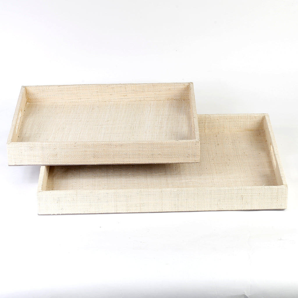 Adie Positively Simple Decorative Trays Set of 2 made from natural plant fibers, displayed on a table with decorative items, showcasing eco-friendly design and multi-purpose functionality for serving and organizing.