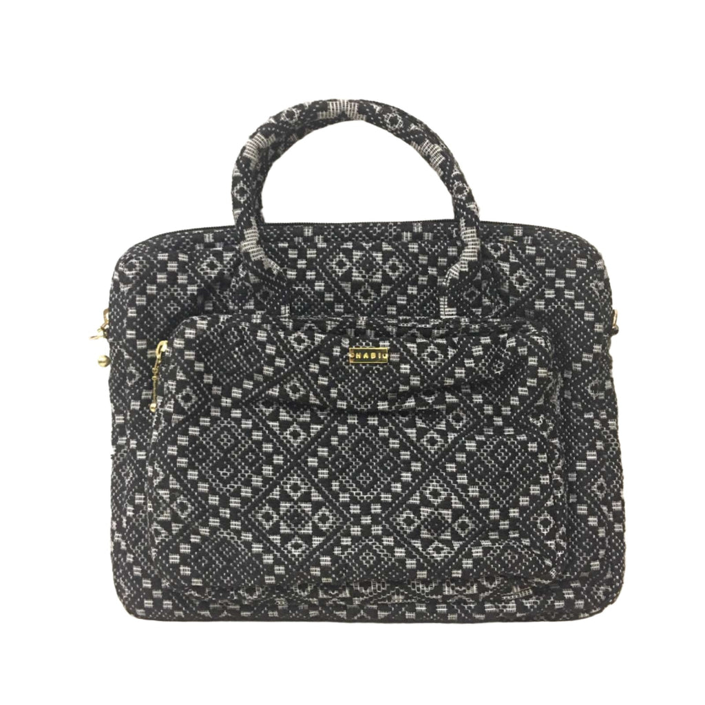 Dani Inabel Black Diamond Laptop Bag, handwoven from Abel Iloco fabric in the Philippines, showcasing intricate geometric patterns inspired by nature. This eco-friendly laptop bag blends traditional craftsmanship and functionality, crafted by skilled Ilocos artisans using centuries-old weaving techniques. Made with 50% cotton and 50% polyester, the bag offers durability with a removable, adjustable cotton strap. 