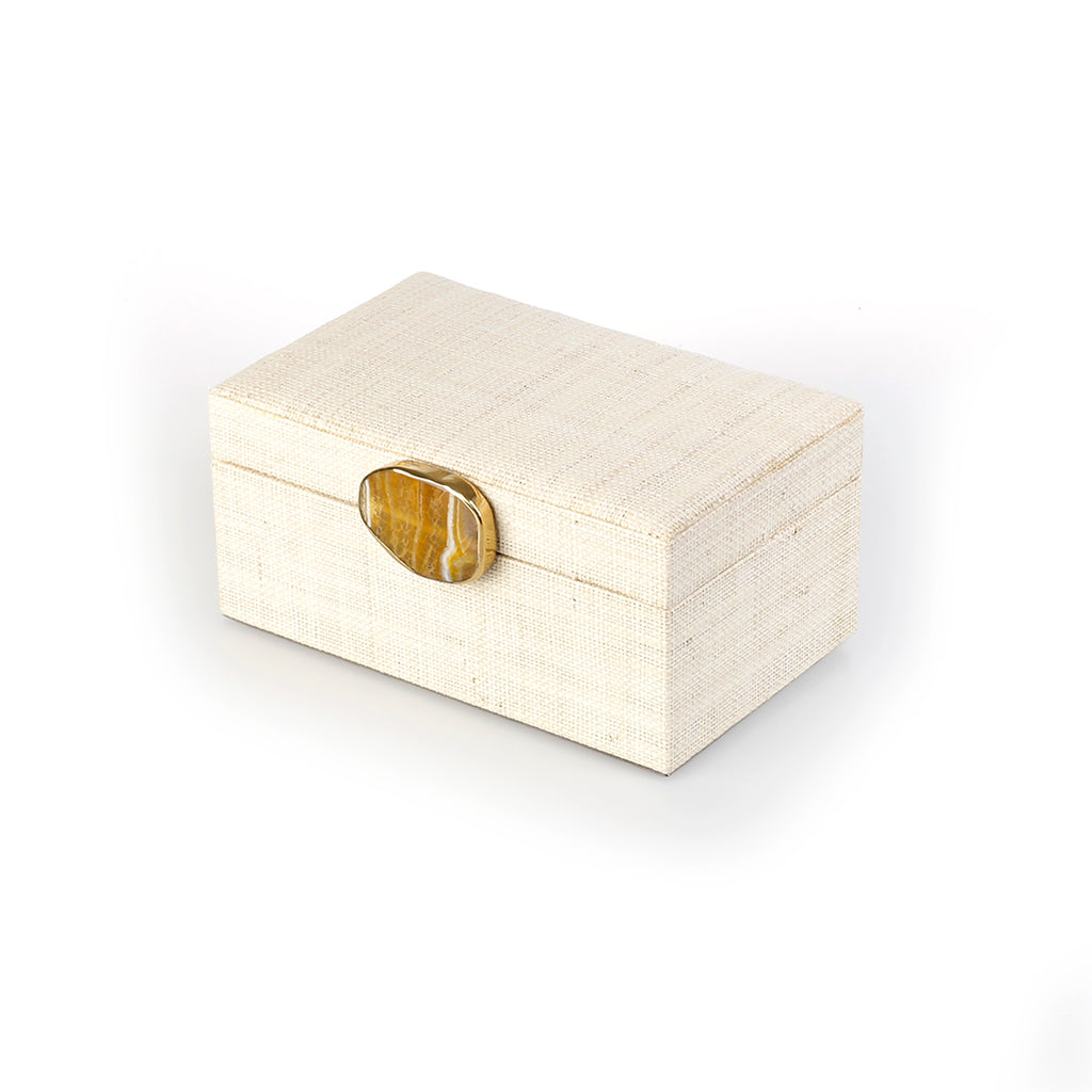 Karuna Raffia Jewelry Box, handcrafted from 100% natural raffia with a polished agate stone accent and hand-tooled brass detailing. Elegant, eco-friendly storage for jewelry and keepsakes.