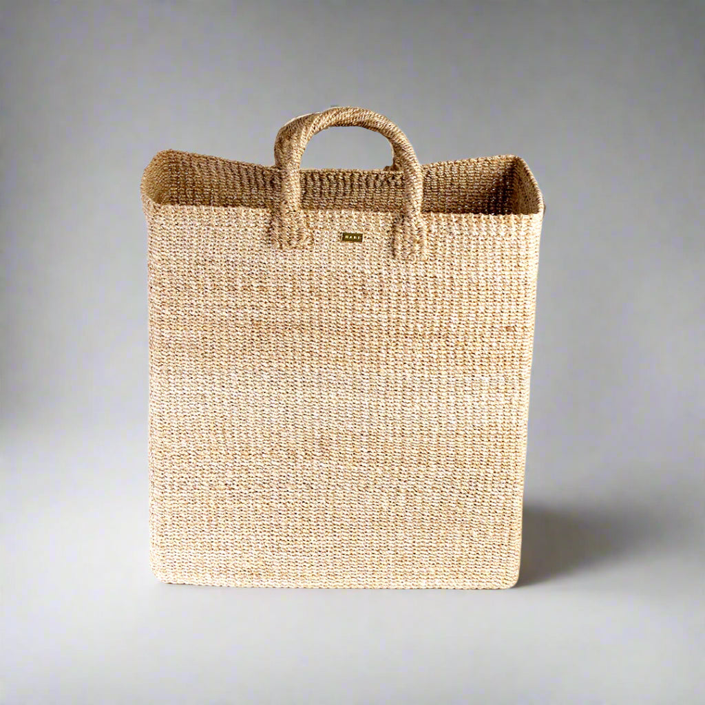 Keep your home organized with the Serene Rectangle Storage Basket. Handwoven from 100% natural plant fiber, this eco-friendly, stylish storage solution is perfect for laundry, sports gear, or seasonal items.