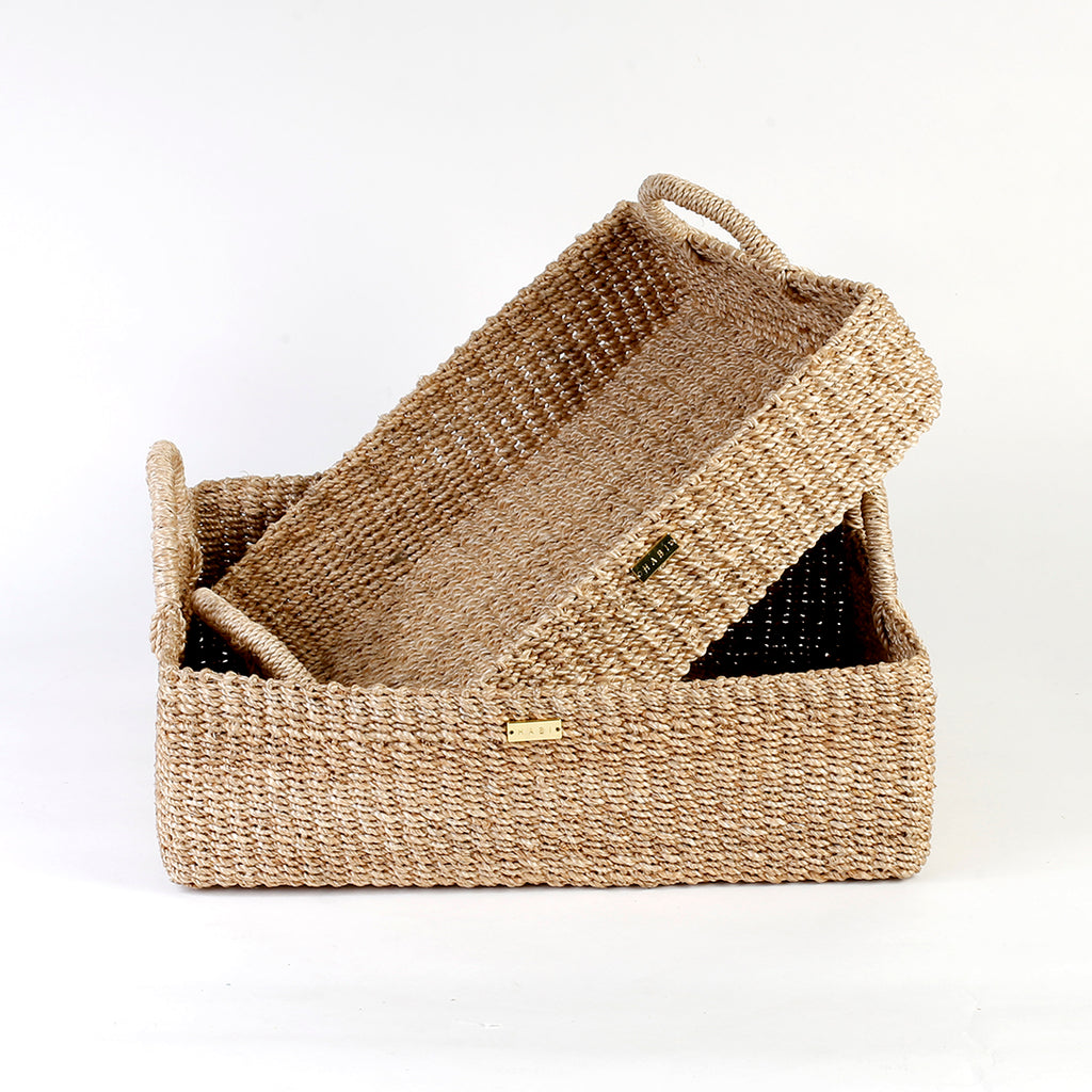 Elevate your home organization with the Stephanie Trays Set of 2. Handwoven from 100% natural plant fiber, these eco-friendly trays offer chic and sustainable storage solutions for any room, enhancing your decor with natural elegance.