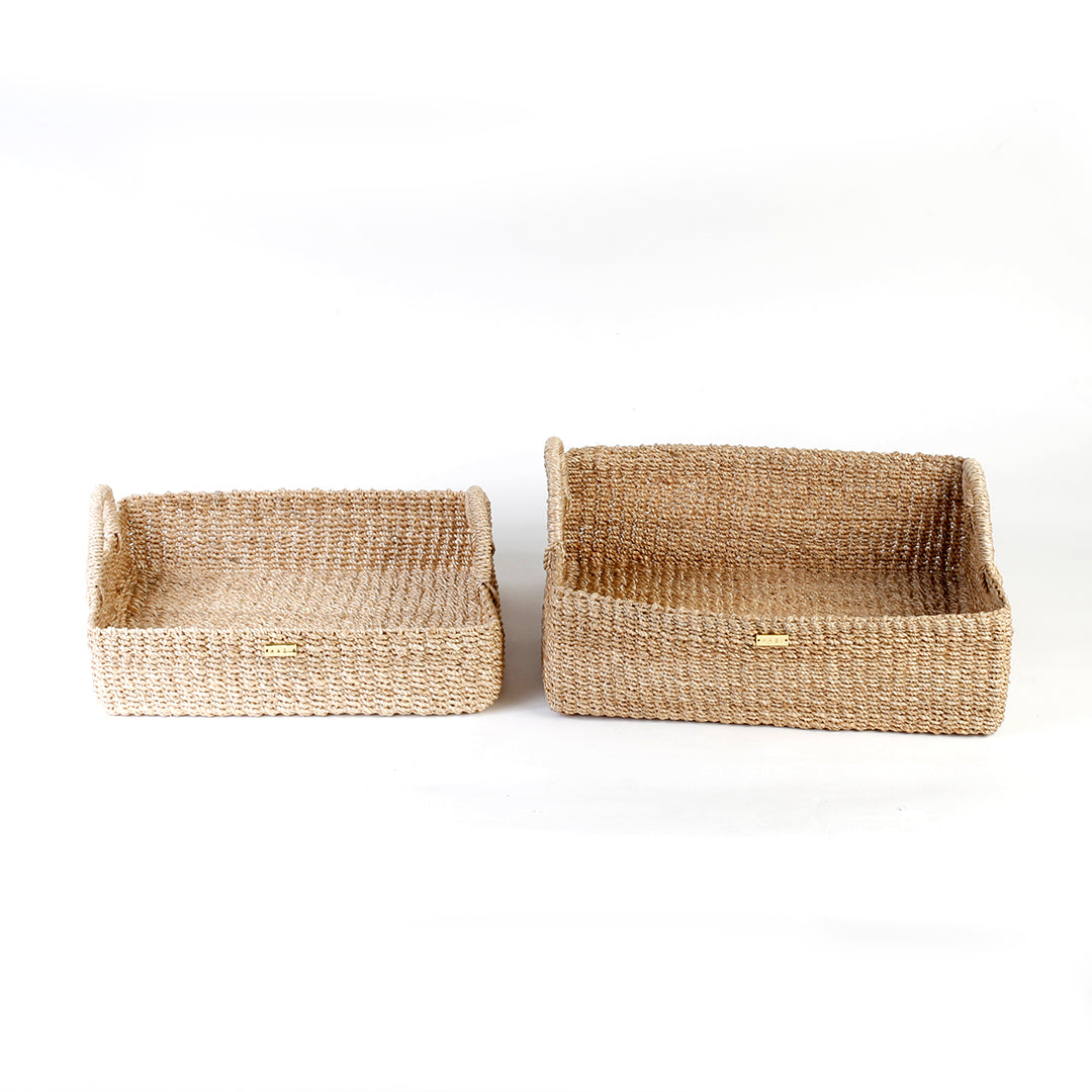 Elevate your home organization with the Stephanie Trays Set of 2. Handwoven from 100% natural plant fiber, these eco-friendly trays offer chic and sustainable storage solutions for any room, enhancing your decor with natural elegance.