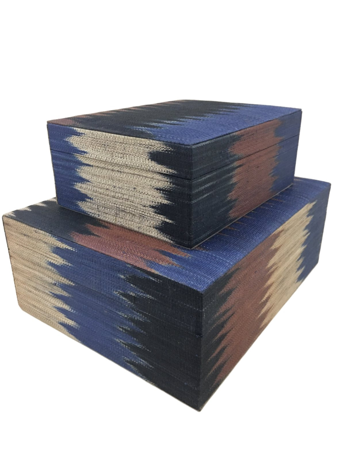 Zia Storage Boxes Set of 2 made from 100% natural plant fiber and adorned with tinalak, a handloomed fabric by the T'boli tribe. Featuring a faux suede lining, these eco-friendly storage boxes provide stylish organization and cultural elegance for any home.