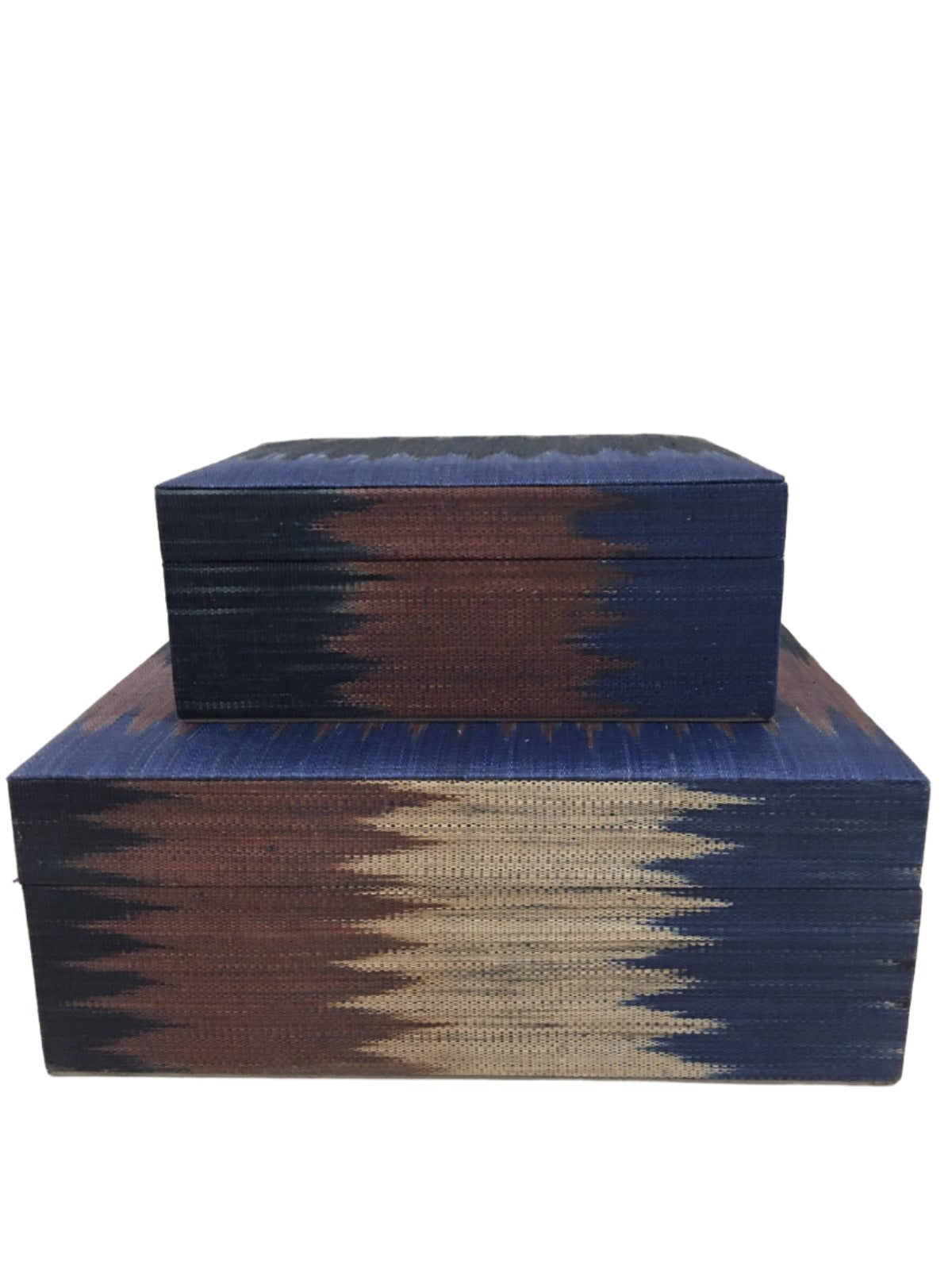 Zia Storage Boxes Set of 2 made from 100% natural plant fiber and adorned with tinalak, a handloomed fabric by the T'boli tribe. Featuring a faux suede lining, these eco-friendly storage boxes provide stylish organization and cultural elegance for any home.